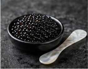 Black caviar presented in a dark bowl